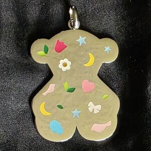 Large TOUS Motif Power pendant in steel and enamel.